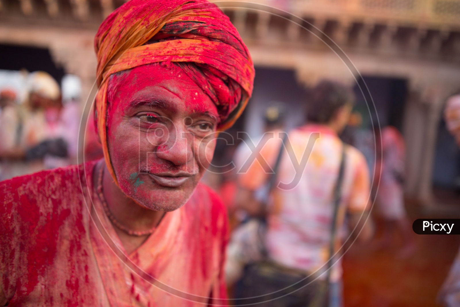 A man's face covered with Holi colors