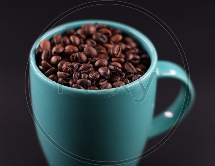 Coffee Beans In  Coffee Mug  Composition Shot On an Isolated Black Background
