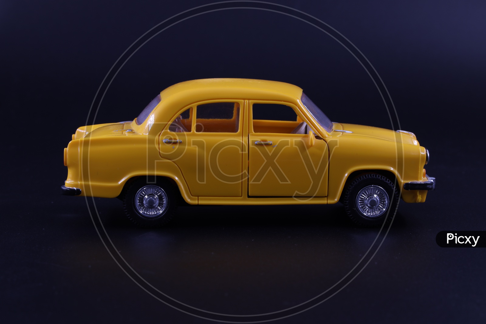 A Yellow Taxi  Or Cab or Car  Toy  Composition Shot On an Isolated Black Background