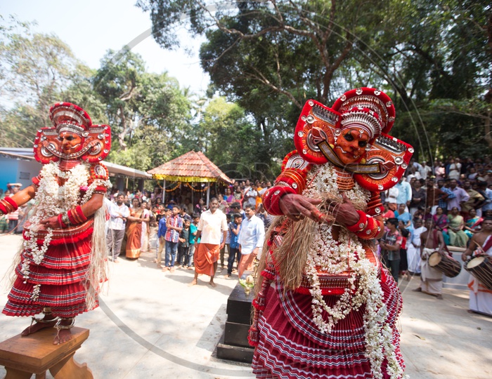 Performers in colourful costume during the performance of Theyyam