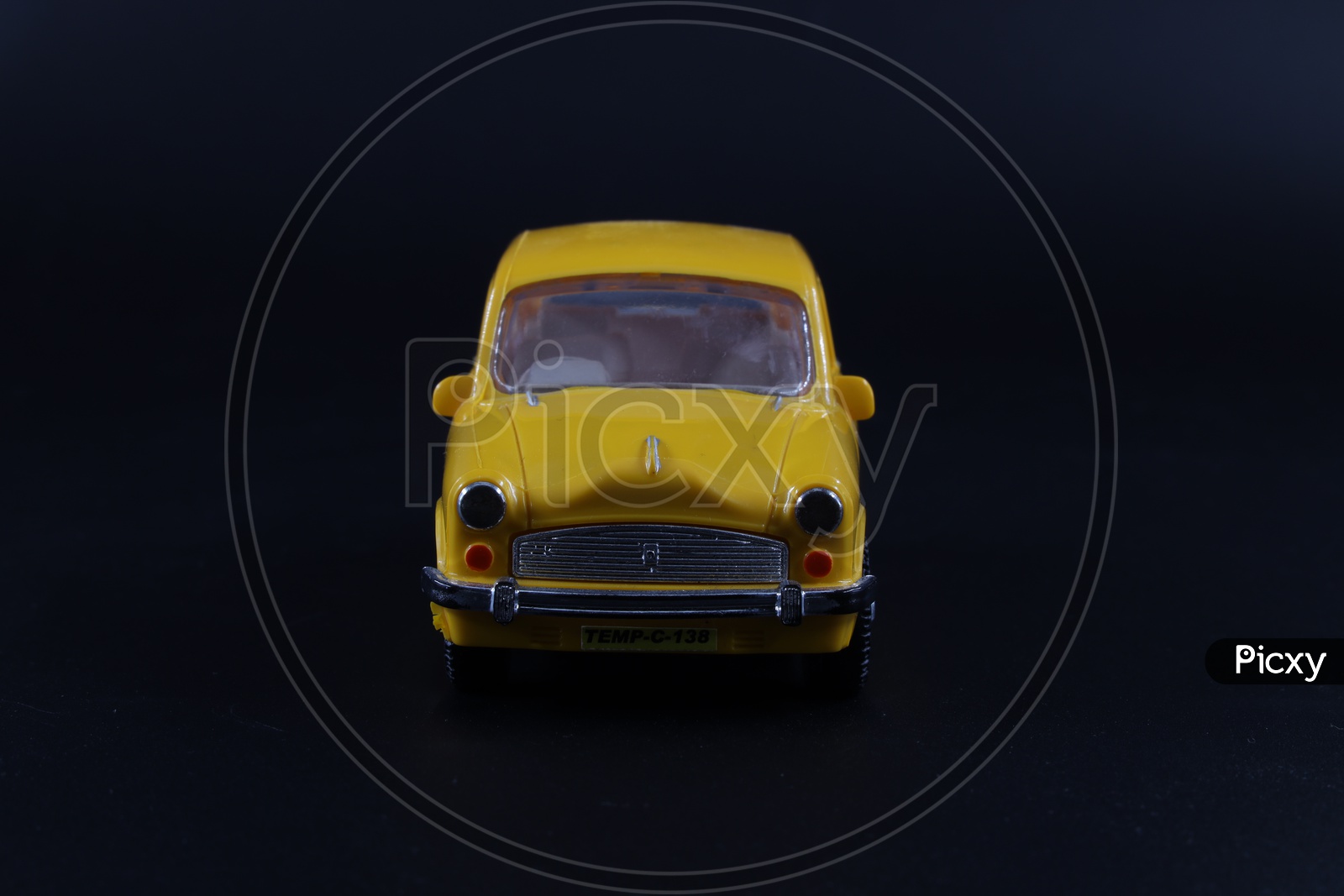 A Yellow Taxi Or Car Or Cab  Toy  Composition Shot On an  Isolated Black Background
