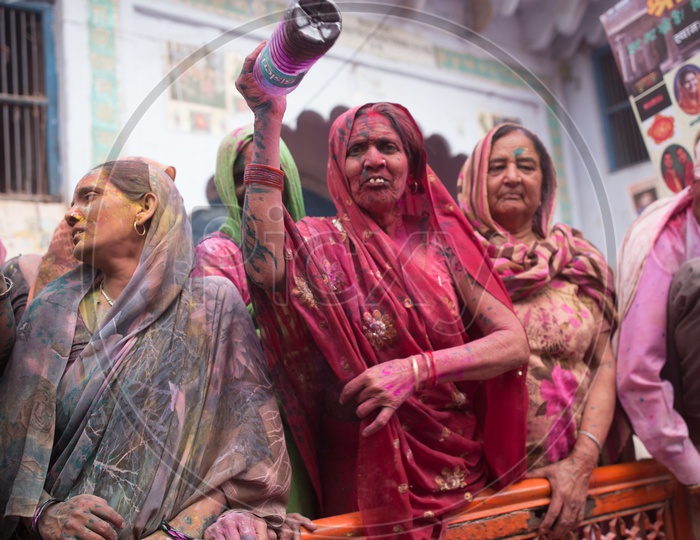 A Woman Filled In Holi Colors With a Color Water Bottle In Hand  At Barsana