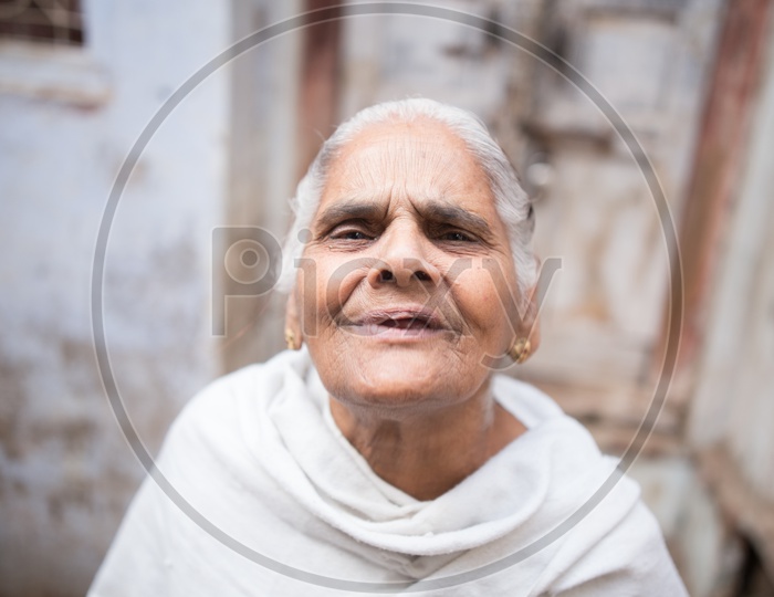 Portrait Of a Old widow Woman On The Streets Of Barsana