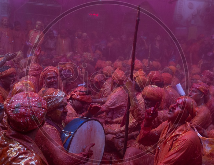 Local People In Barsana Celebrating Lathmar Holi as a Crowd Singing Songs And  Playing Drums Siting  With Color And Water Spalsh