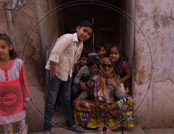 An old woman along with the children posing for a photograph