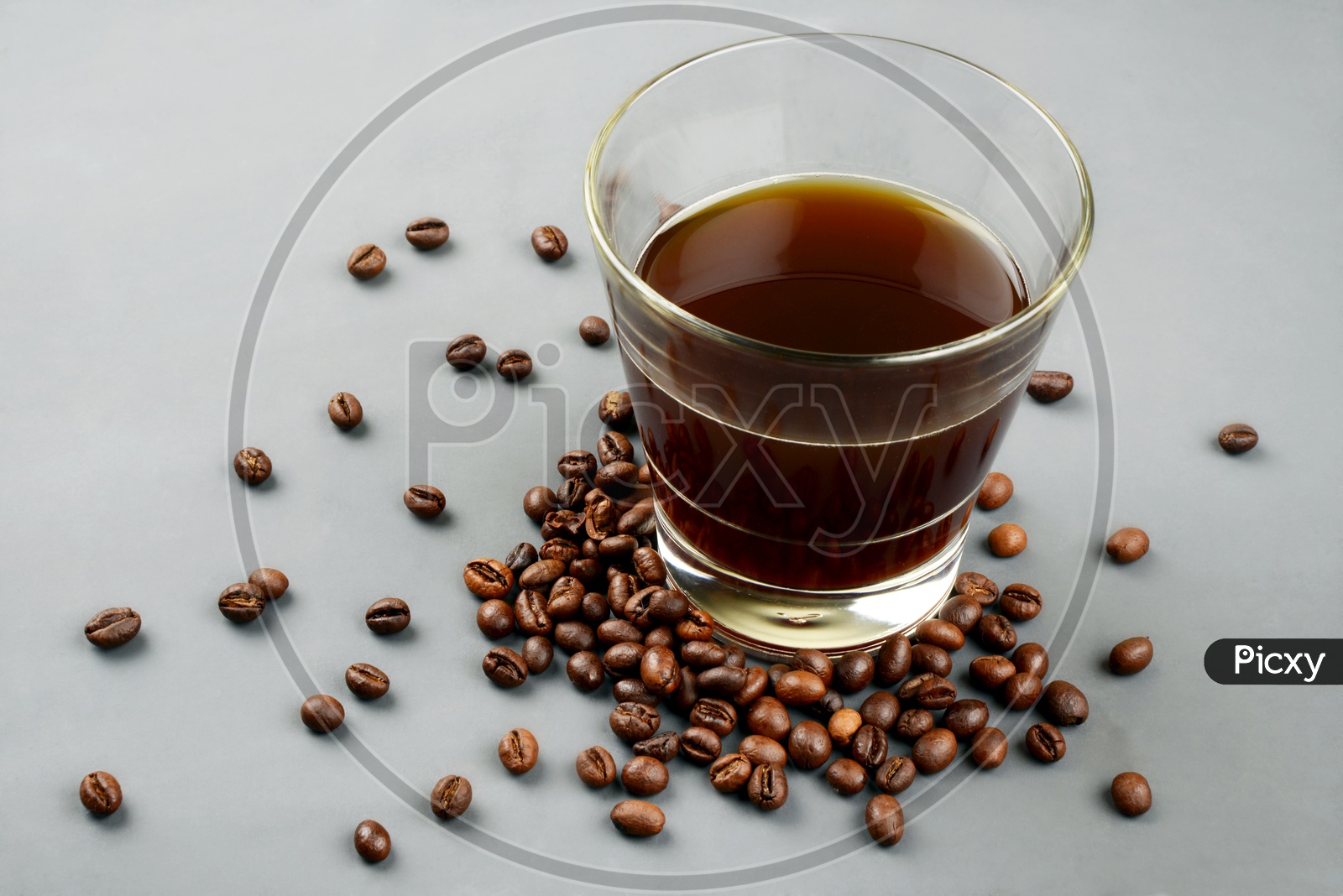Roasted Coffee beans with a glass of black coffee