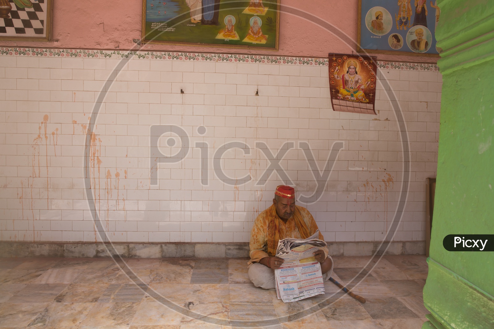 An Indian man reading newspaper