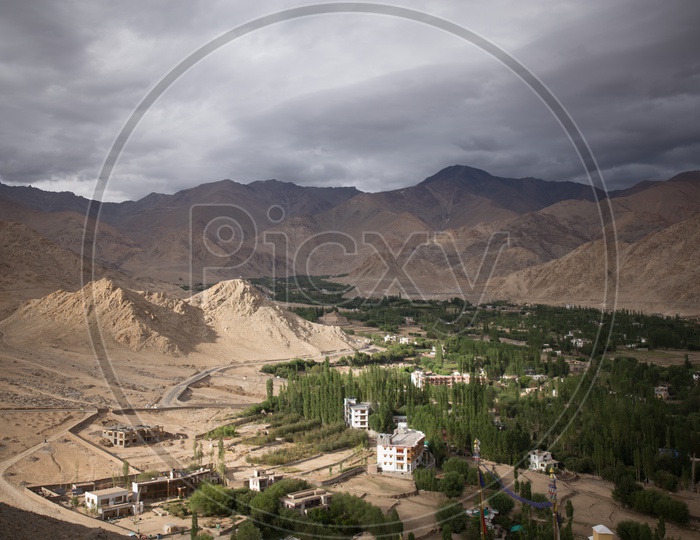 Landscape of Snow Capped Mountains of Leh with houses in the foreground
