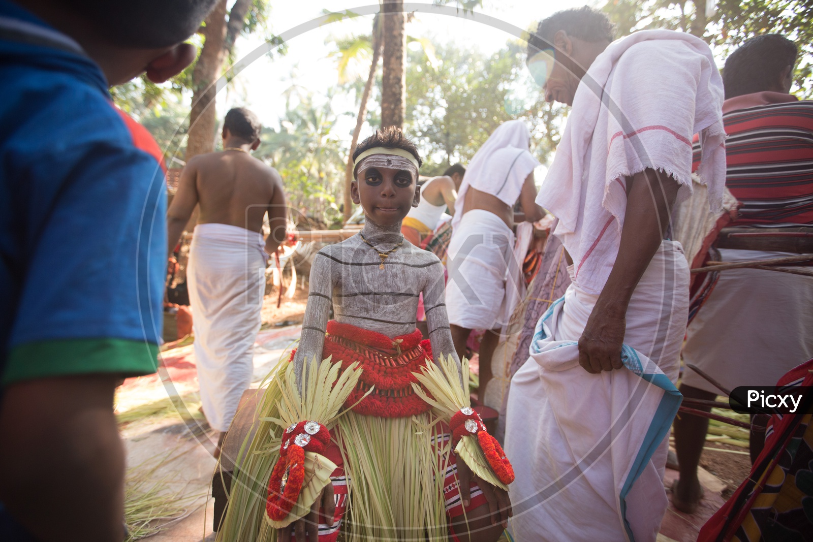 A Small Boy Theyyam Artists In Makeup For Performance , A  Ritualistic Dance Art Form  in Kerala