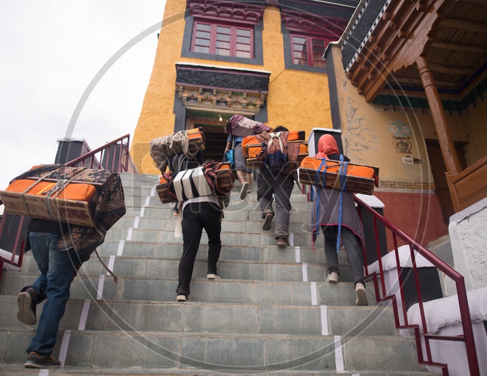 People carrying bags to the monastery