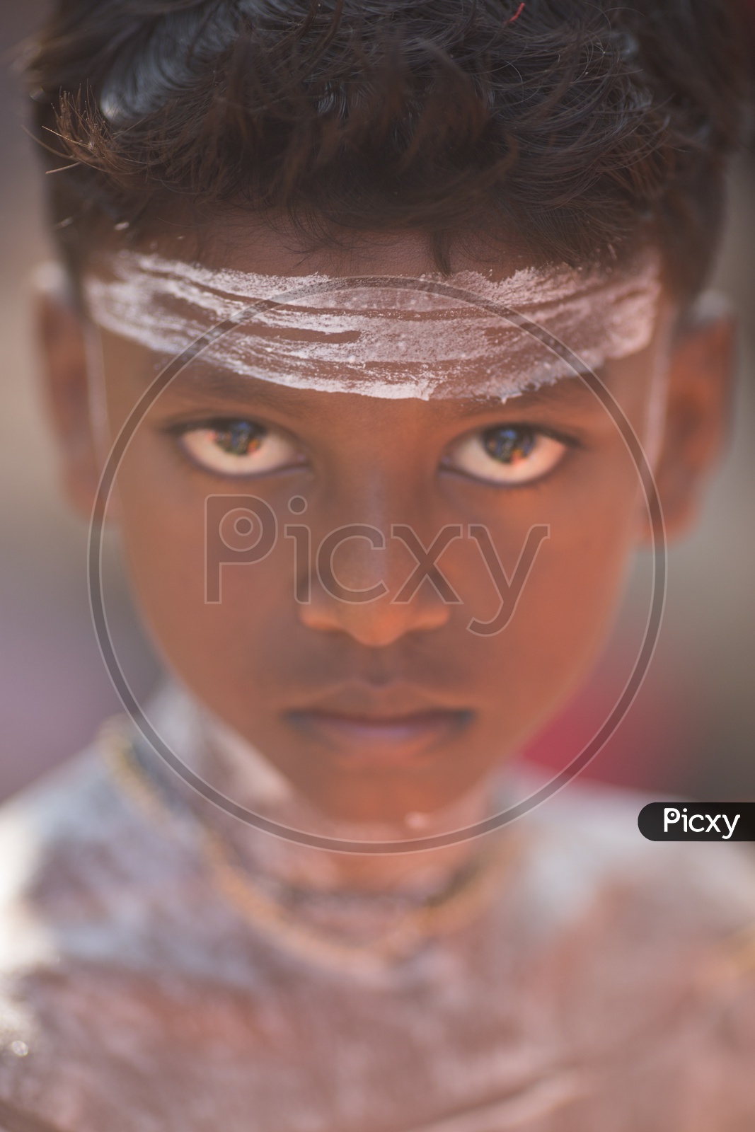 Portrait Of a Young Boy In Makeup for Theyyam Performance