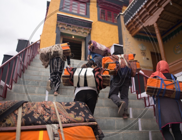 People carrying kits into the monastery