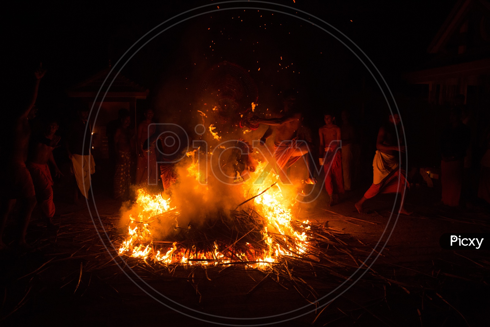 Theyyam Artists Performing Around The Fire At Bhagawathi Amman Temples As a a Ritual In Theyyam Celebrations