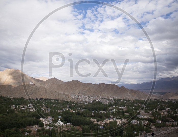 Beautiful Landscape of Snow Capped Mountains of Leh with houses in the foreground