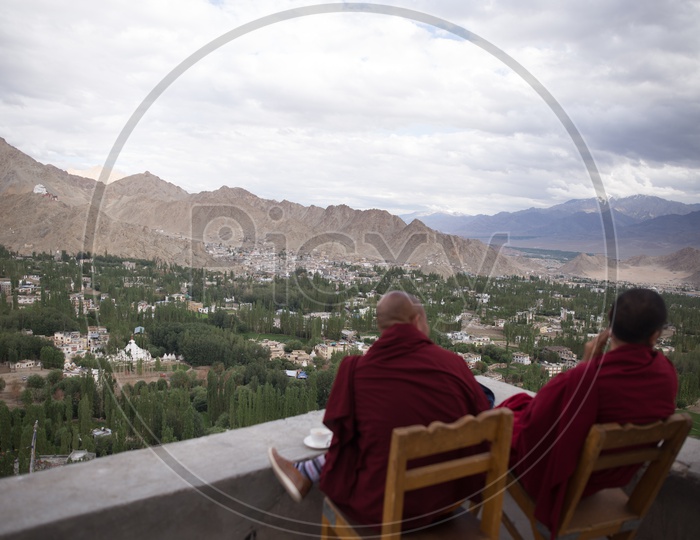 Two Buddhist Monks sitting in chairs