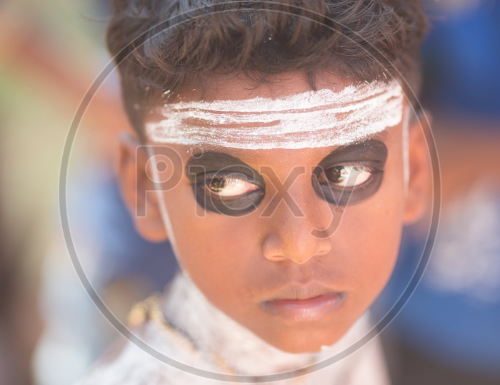 Portrait Of a Young Boy In Theyyam Artist Makeup For Performance