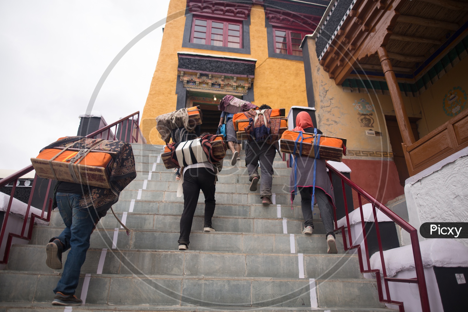 People carrying bags to the monastery
