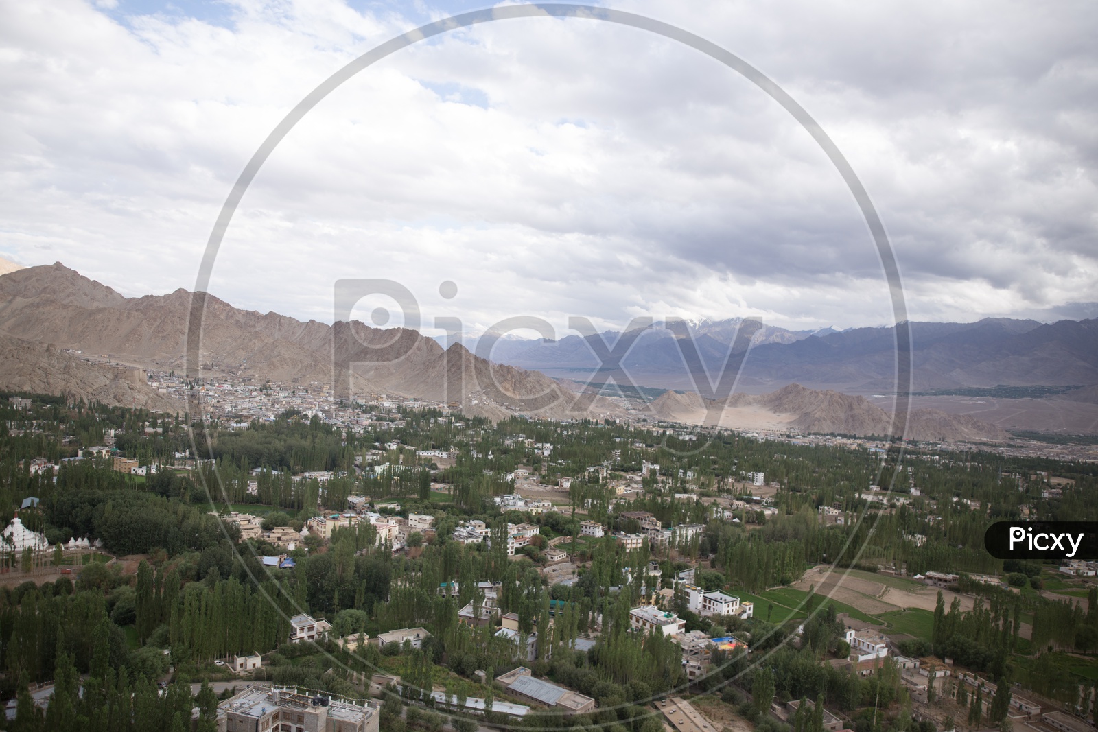 Beautiful Landscape of Snow Capped Mountains of Leh with houses in the foreground