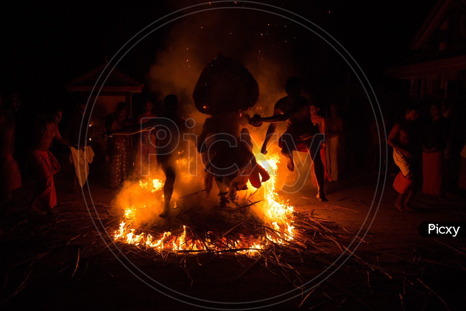Theyyam Artists Performing Around The Fire At Bhagawathi Amman Temples As a a Ritual In Theyyam Celebrations