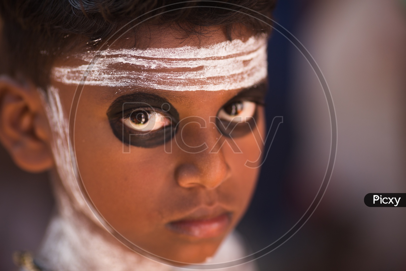 Portrait Of a Young Boy In Makeup for Theyyam Performance