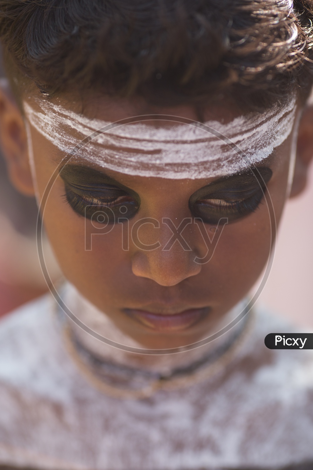 Portrait Of a Young Boy In Theyyam Artist Makeup For Performance