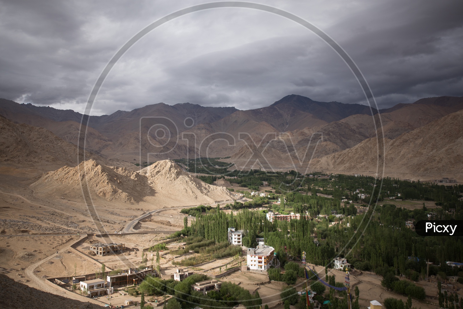 Landscape of Snow Capped Mountains of Leh with houses in the foreground