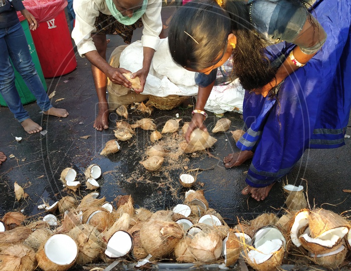 Hindu Devotees Breaking Dried Coconuts At Temples