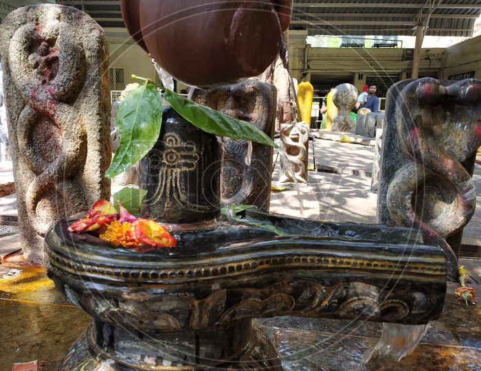 Hindu Devotees Performing  Pooja Or Abhishekam For Lord Shiva Idol