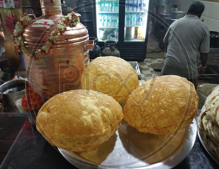 Indian Breakfast Puri Or Wheat Flour Ball in Street Food Vendor Stalls