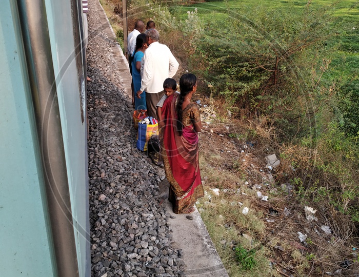 Passengers Or Pedestrain Standing Besides Moving Train