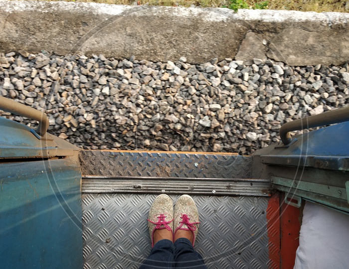 A Young Girl Foot Standing At Train Door Step