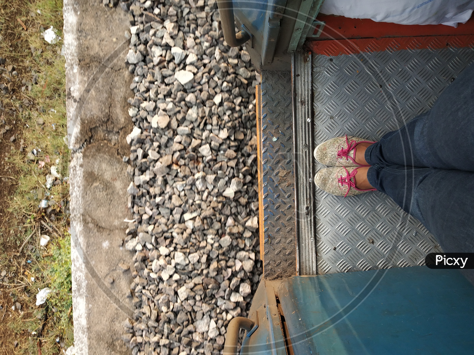 A Young Girl Foot Standing At Train Door Step