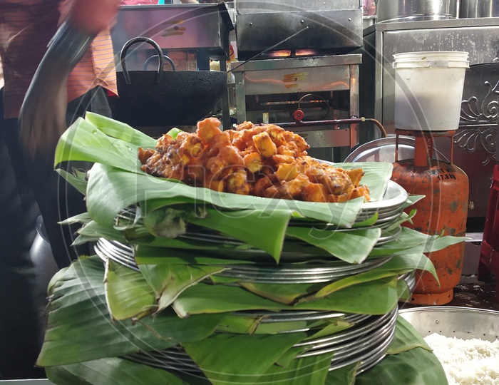 Street Food Being Served In Plates Covered With Banana Leafs