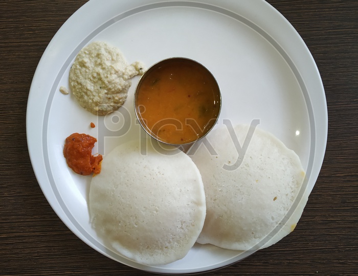 Indian Breakfast Idly Served In a Plate Along With Chutney and Sambar