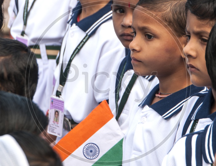 Indian School Children Wearing Uniform And Holding Indian National Flag in Assembly on  Independence Day Celebrations