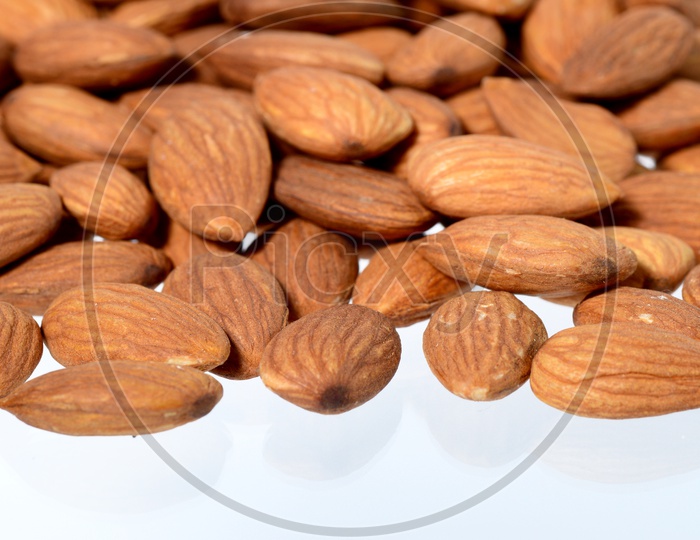 Almonds Or Badam Nuts Pile On an Isolated White Background