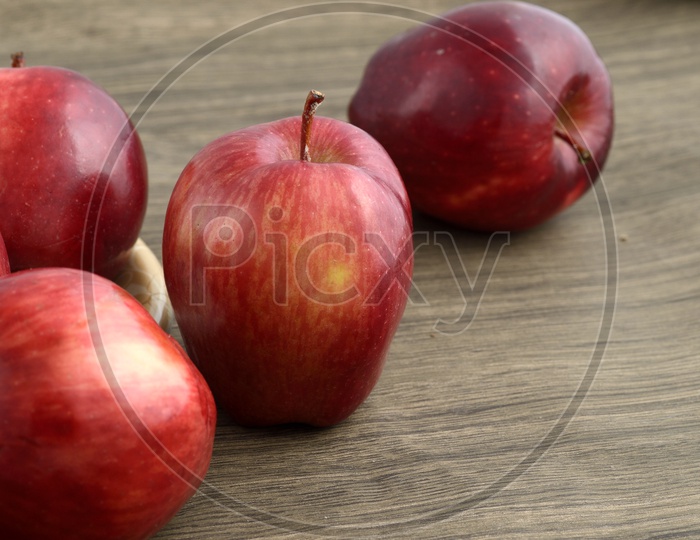 Ripen Red Apples On an Wooden  Background
