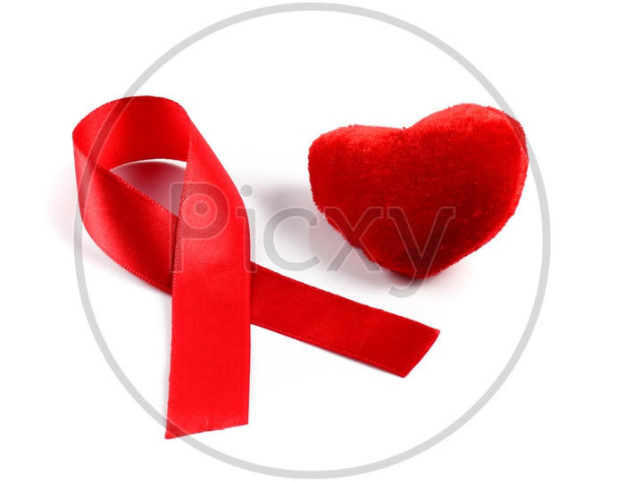 Aids ribbon and heart on white background.