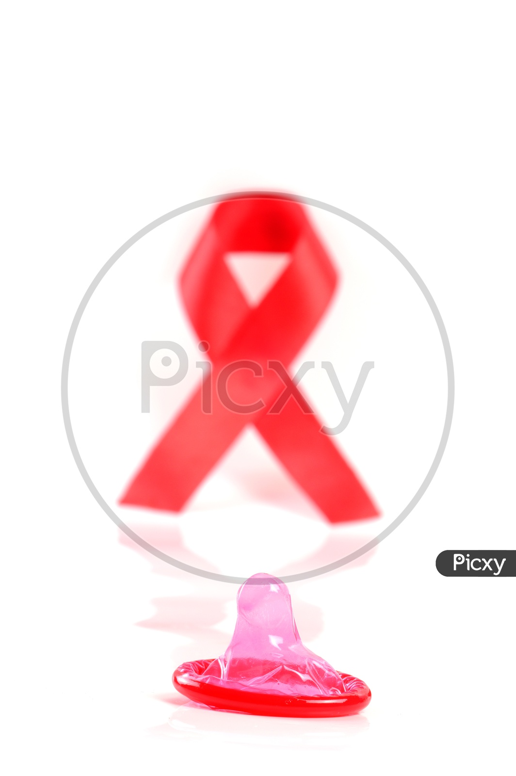Aids ribbon and condom on white background.