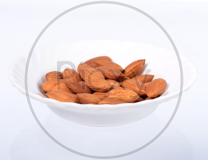 Almonds or Badam in a Bowl On an Isolated White Background