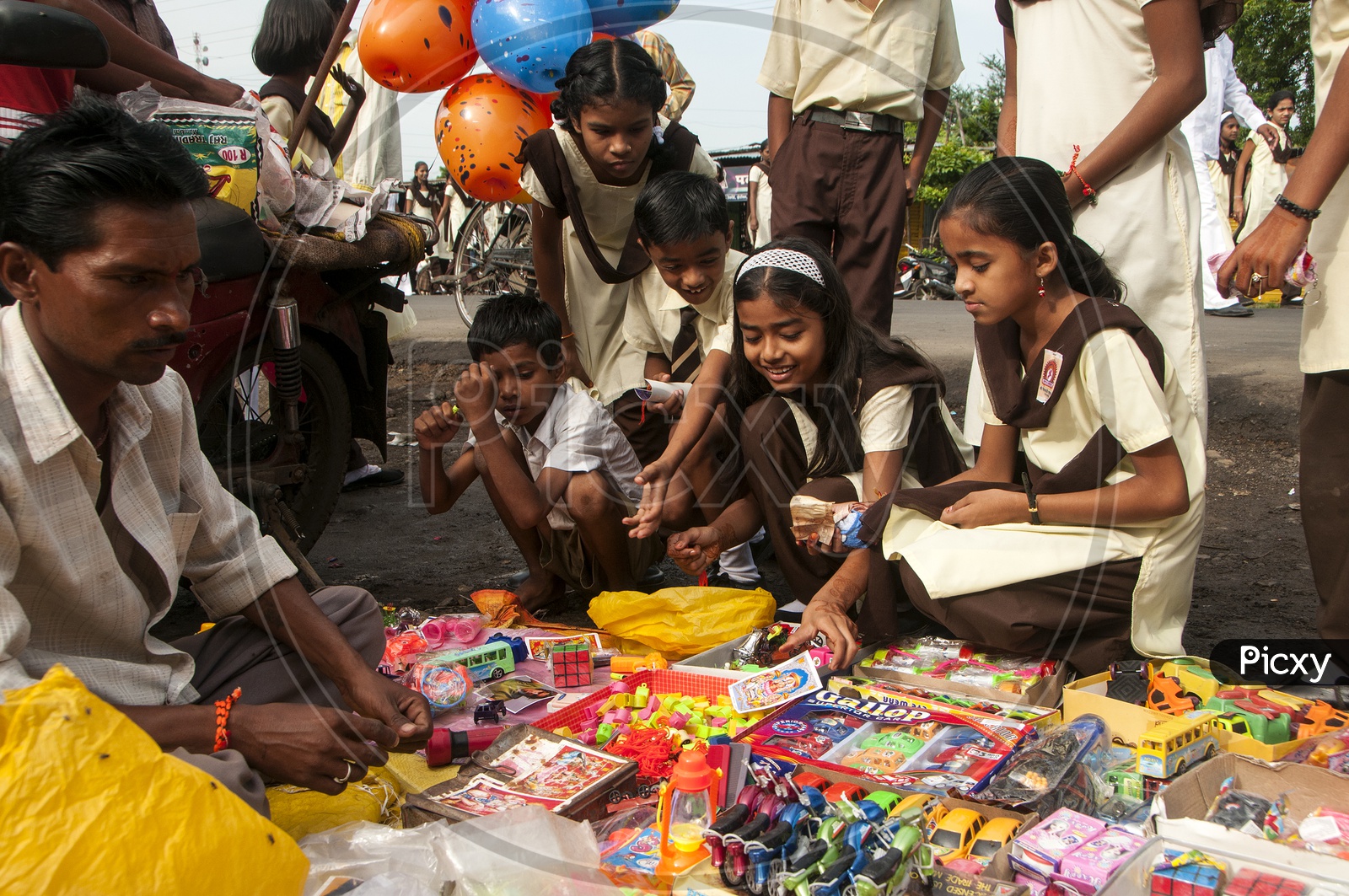 School Children Buying Toys From a  Vendor Stall