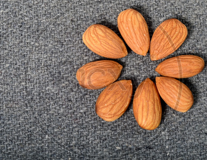 Almonds Or Badam Nuts Arranged On an Isolated  Background