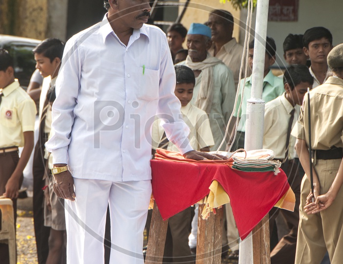 School Teacher At Independence Day Flag Hoisting Pole In a School