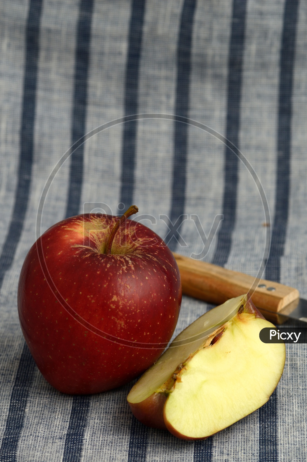 Fresh Red Apples And Slices With Knife  on an Table Cloth Background