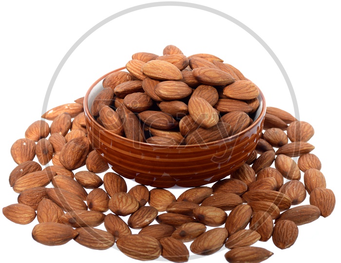 Almonds Or Badam Nuts Heap In a Bowl On an Isolated White Background
