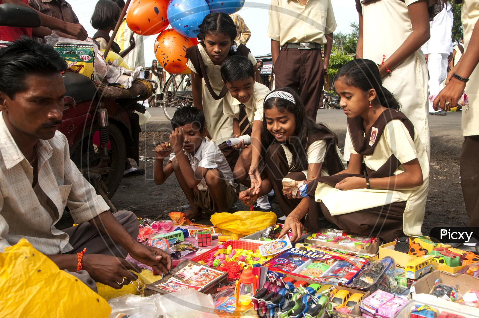 School Children Buying Toys From a  Vendor Stall