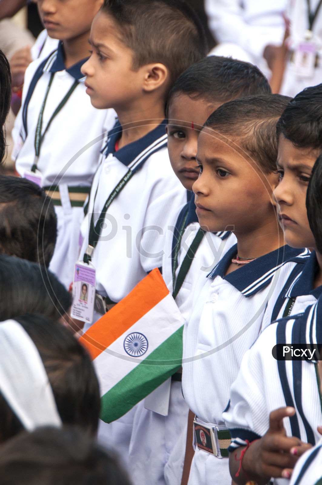 Indian School Children Wearing Uniform And Holding Indian National Flag in Assembly on  Independence Day Celebrations