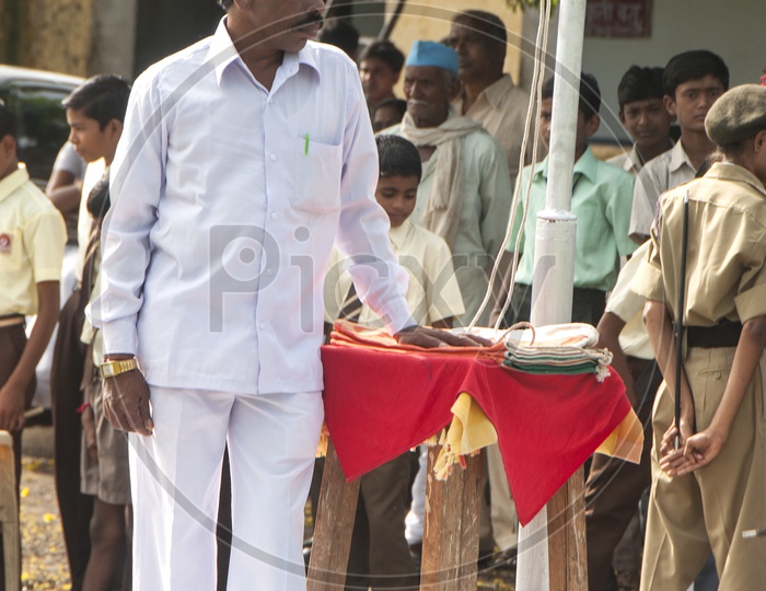 School Teacher At Independence Day Flag Hoisting Pole In a School