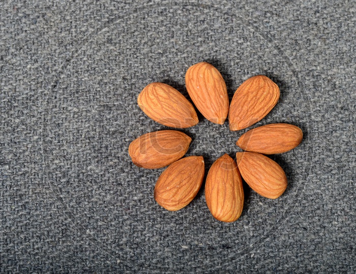 Almonds Or Badam Nuts Arranged On an Isolated  Background