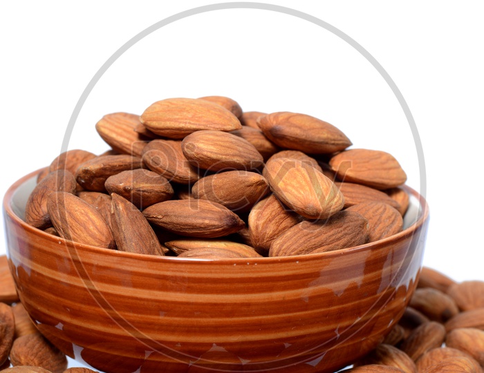Almonds Or Badam Nuts Heap  In a  Bowl On an Isolated White Background